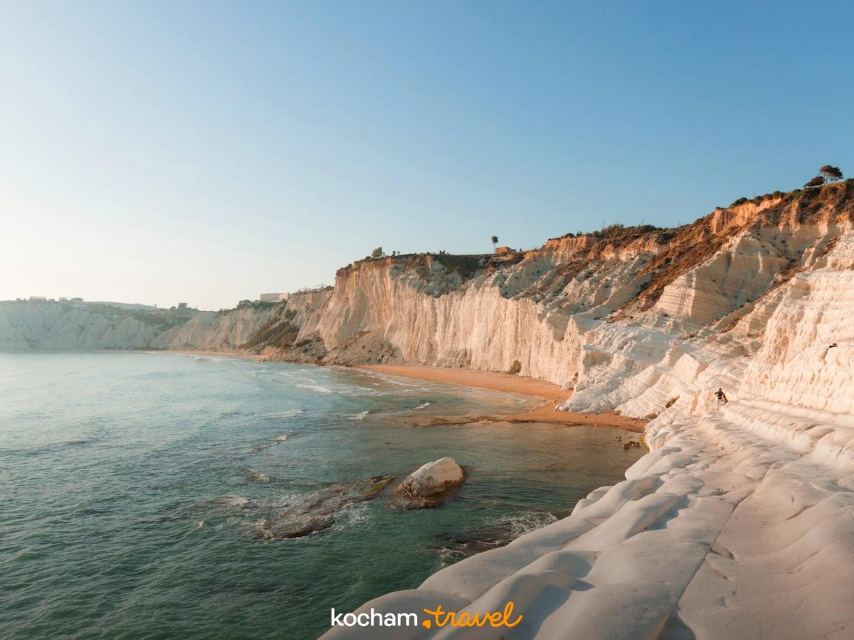 Białe klify Scala dei Turchi, piaszczysta plaża i turkusowe morze.