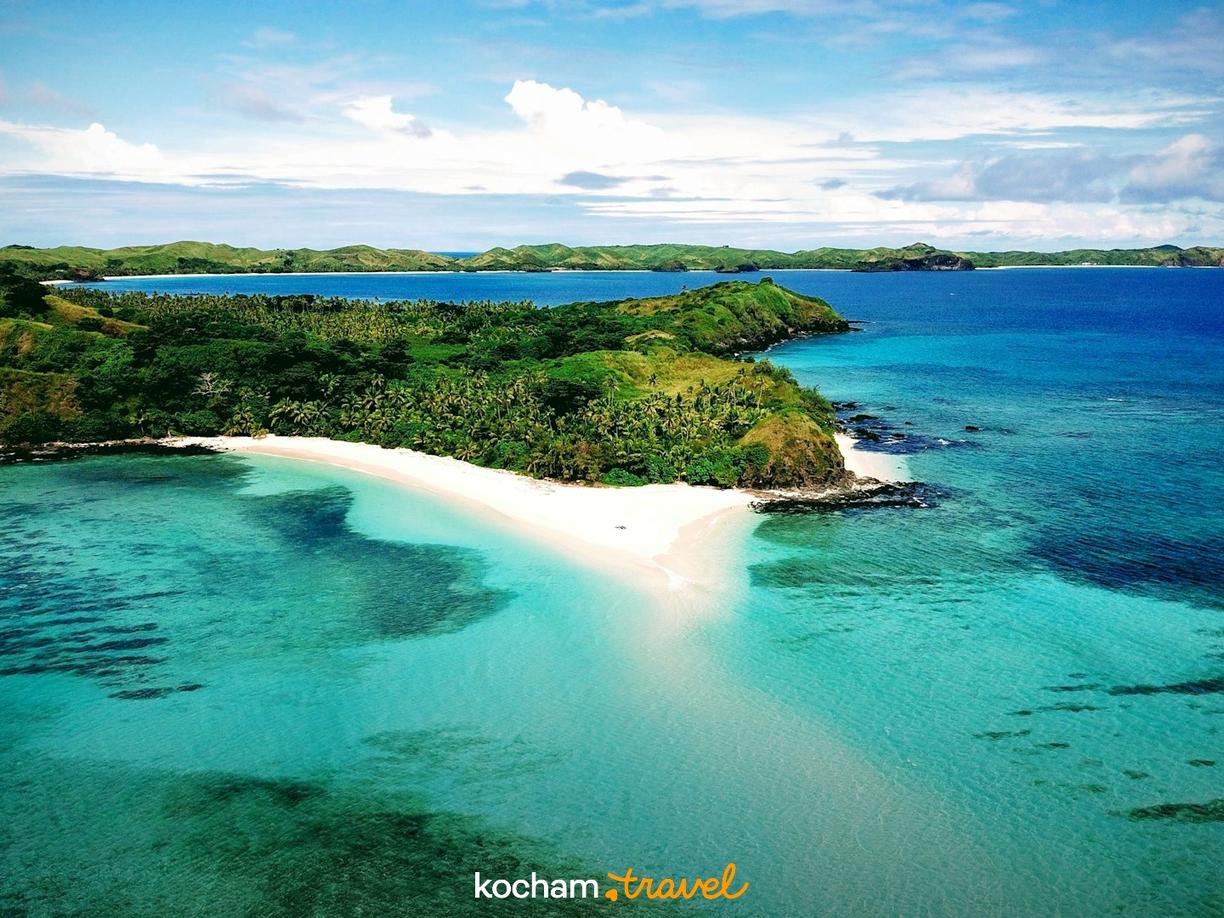 Rajska plaża z białym piaskiem i turkusowymi wodami oceanu.