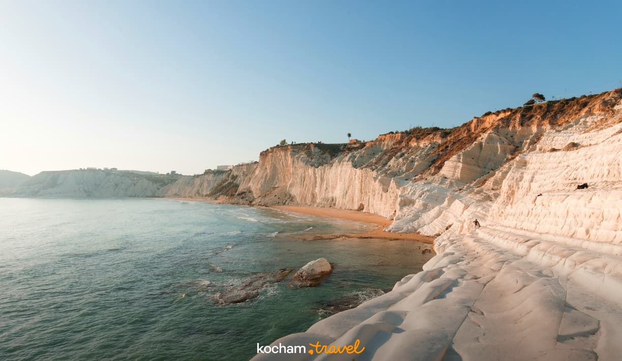 Białe klify Scala dei Turchi, piaszczysta plaża i turkusowe morze.