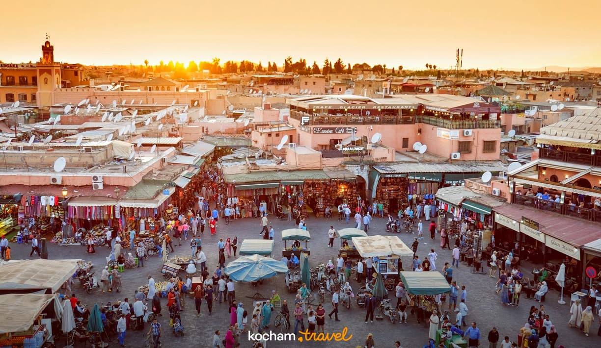 Tętniący życiem plac Jemaa el-Fna w Marrakeszu o zachodzie słońca.