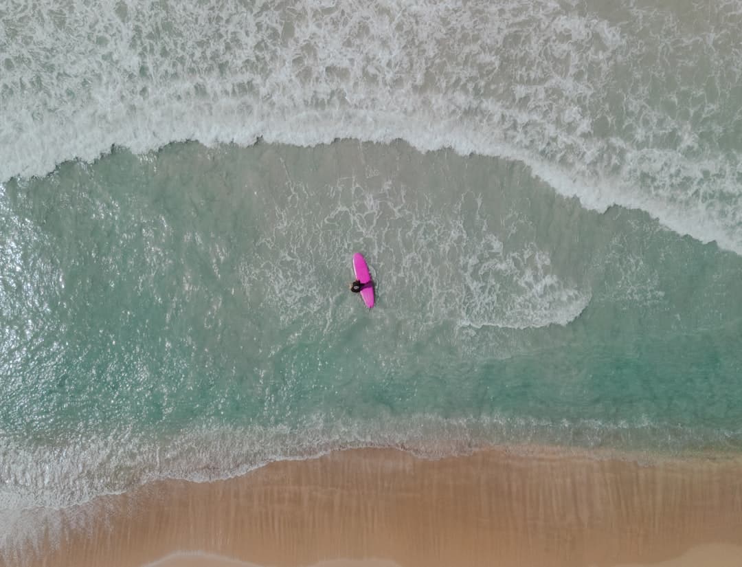 Osoba surfująca na wietrznej plaży Lanzarote