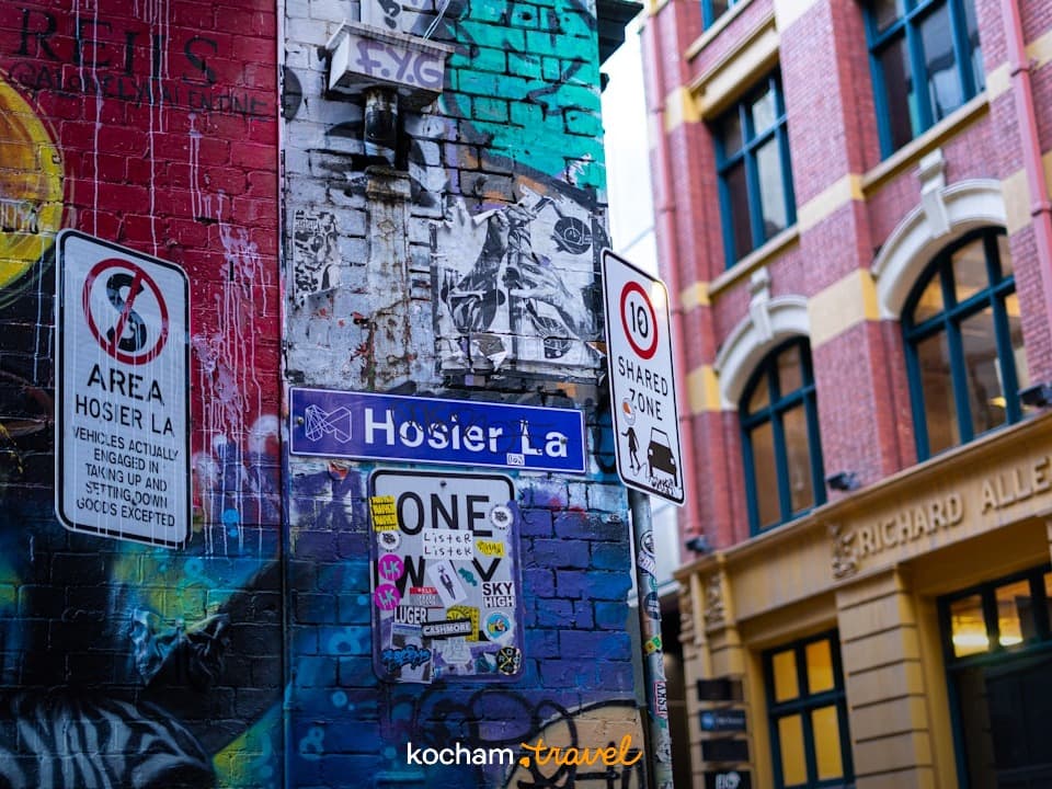 Kolorowe graffiti na ceglanej ścianie, znaki uliczne, Hosier Lane, Melbourne.