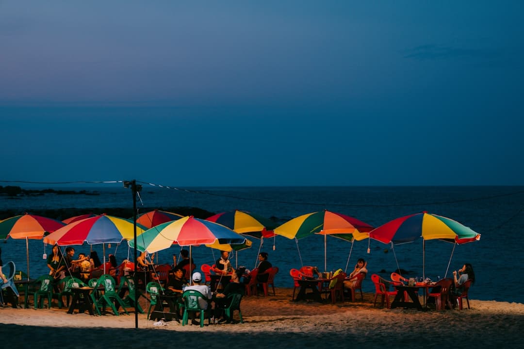 Plażowa impreza z parasolami o zmierzchu.